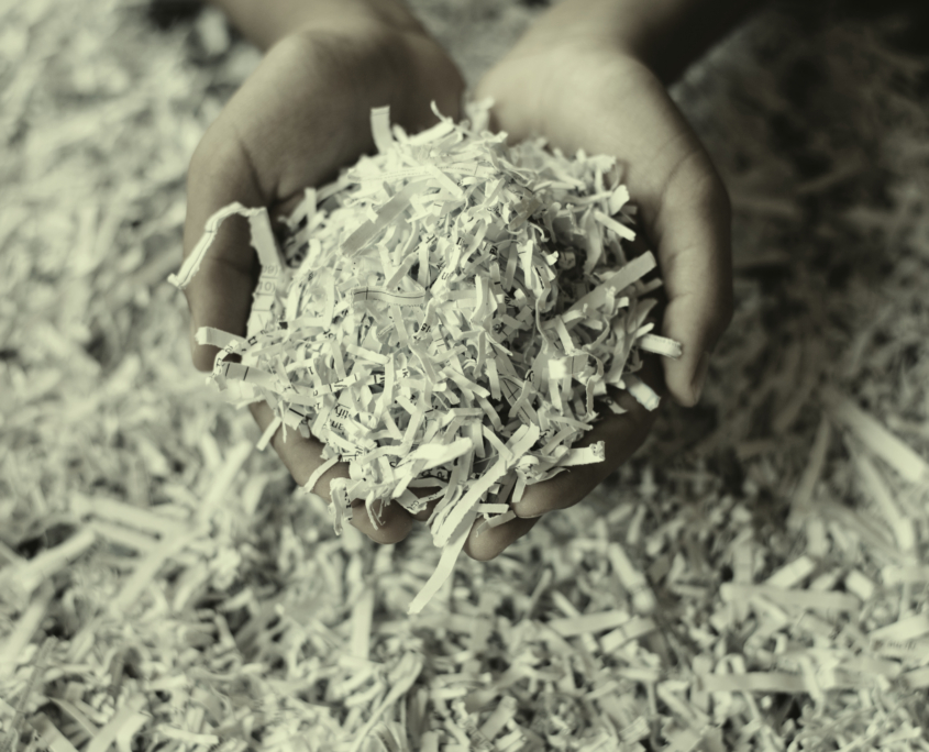 Hand,Showing,Heap,Of,Shredded,Paper.,Concept,Of,Recycle,And
